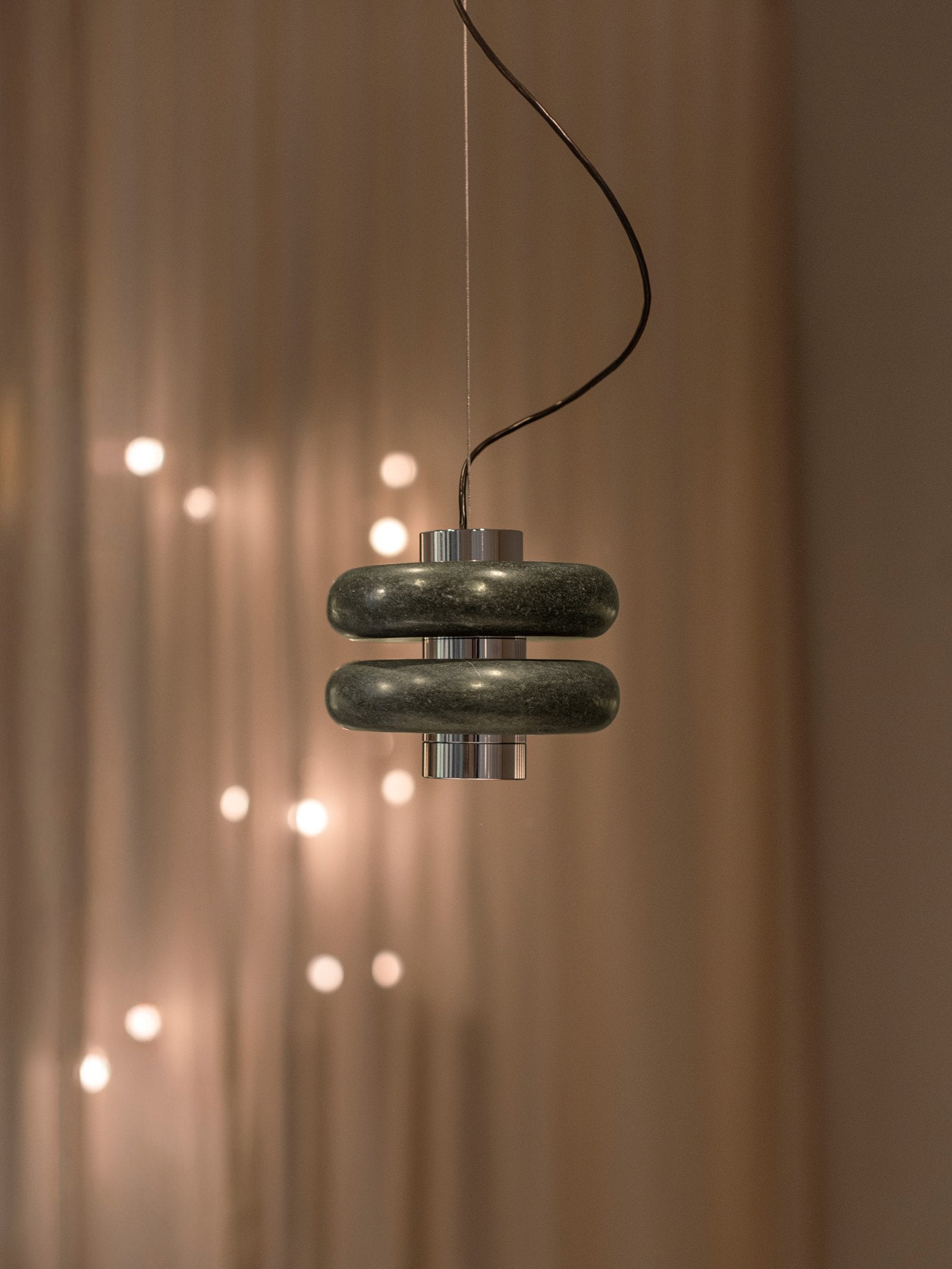 Duo Marble Pendant Lamp in green against a dark background.