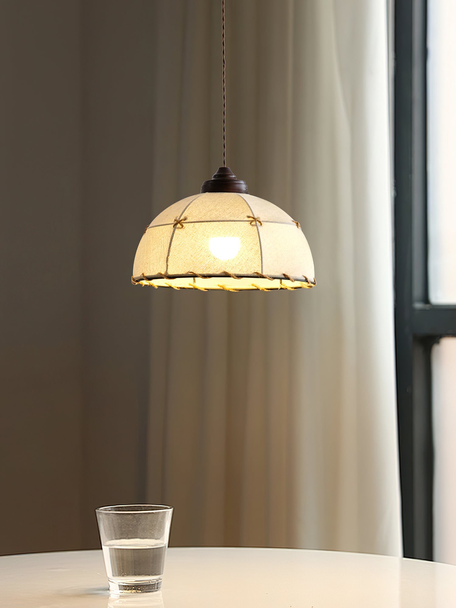 Detail shot of the walnut-colored wood and metal frame of the Duomo Pendant Light.