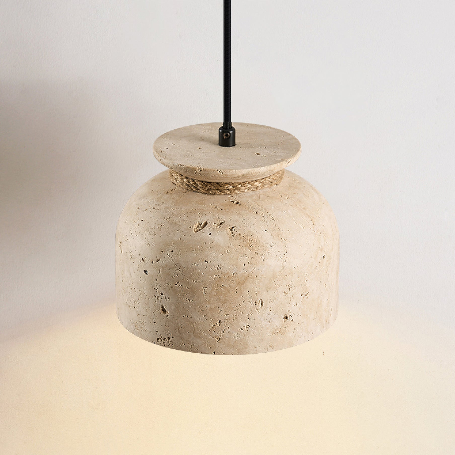 Close-up view of the Easton Pendant Lamp's travertine texture and wood detail.