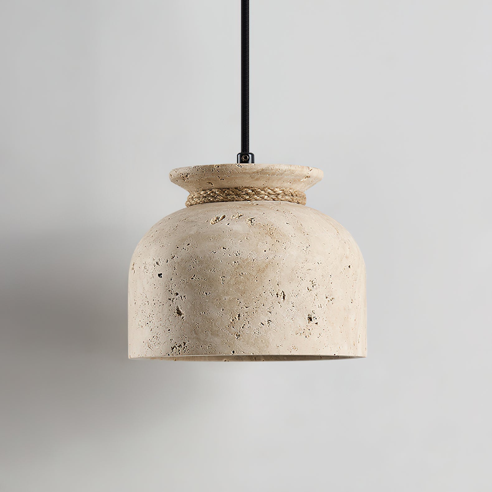 Detail shot showing the light bulb inside the travertine shade.