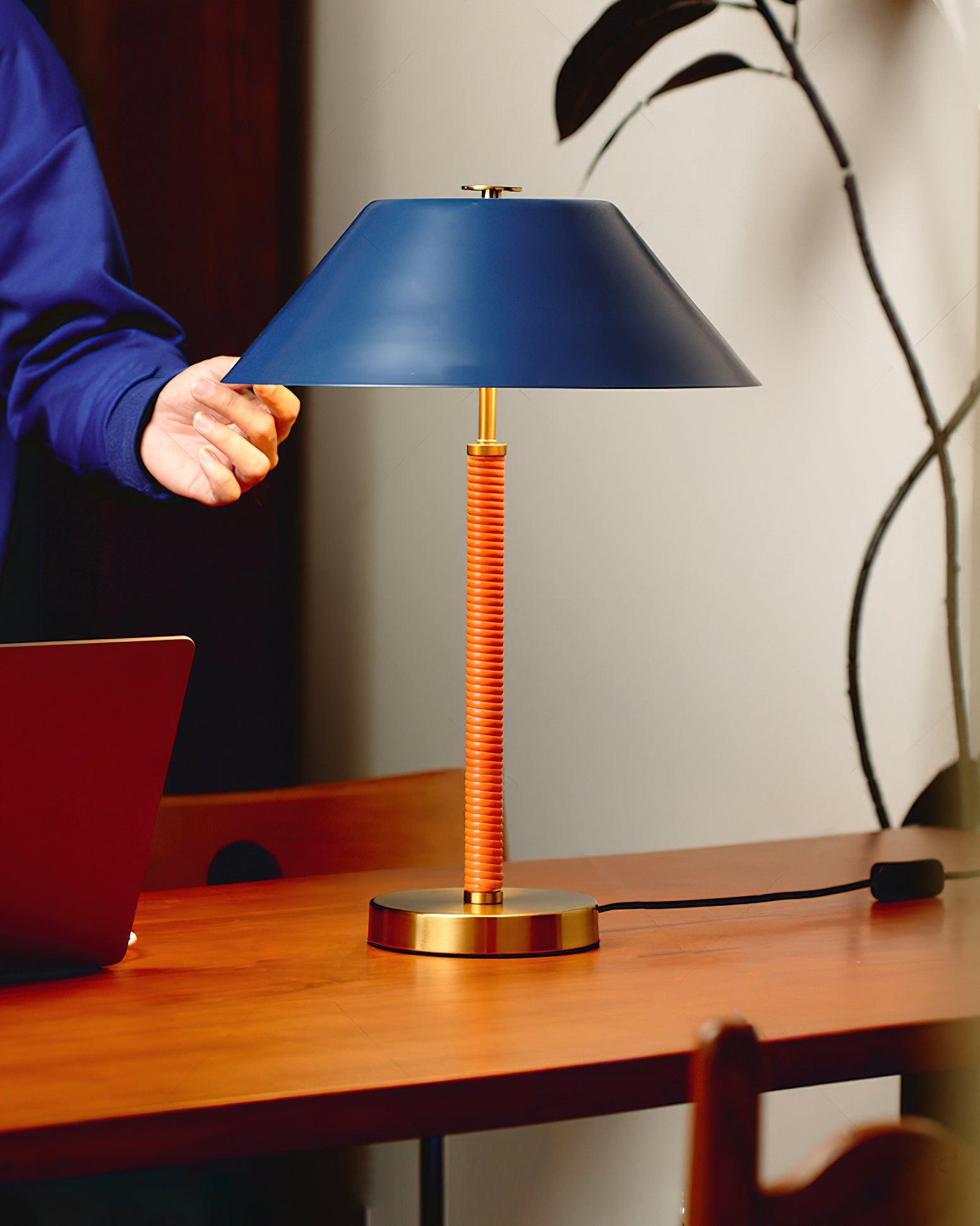 The Eave Table Lamp shown on a modern side table.