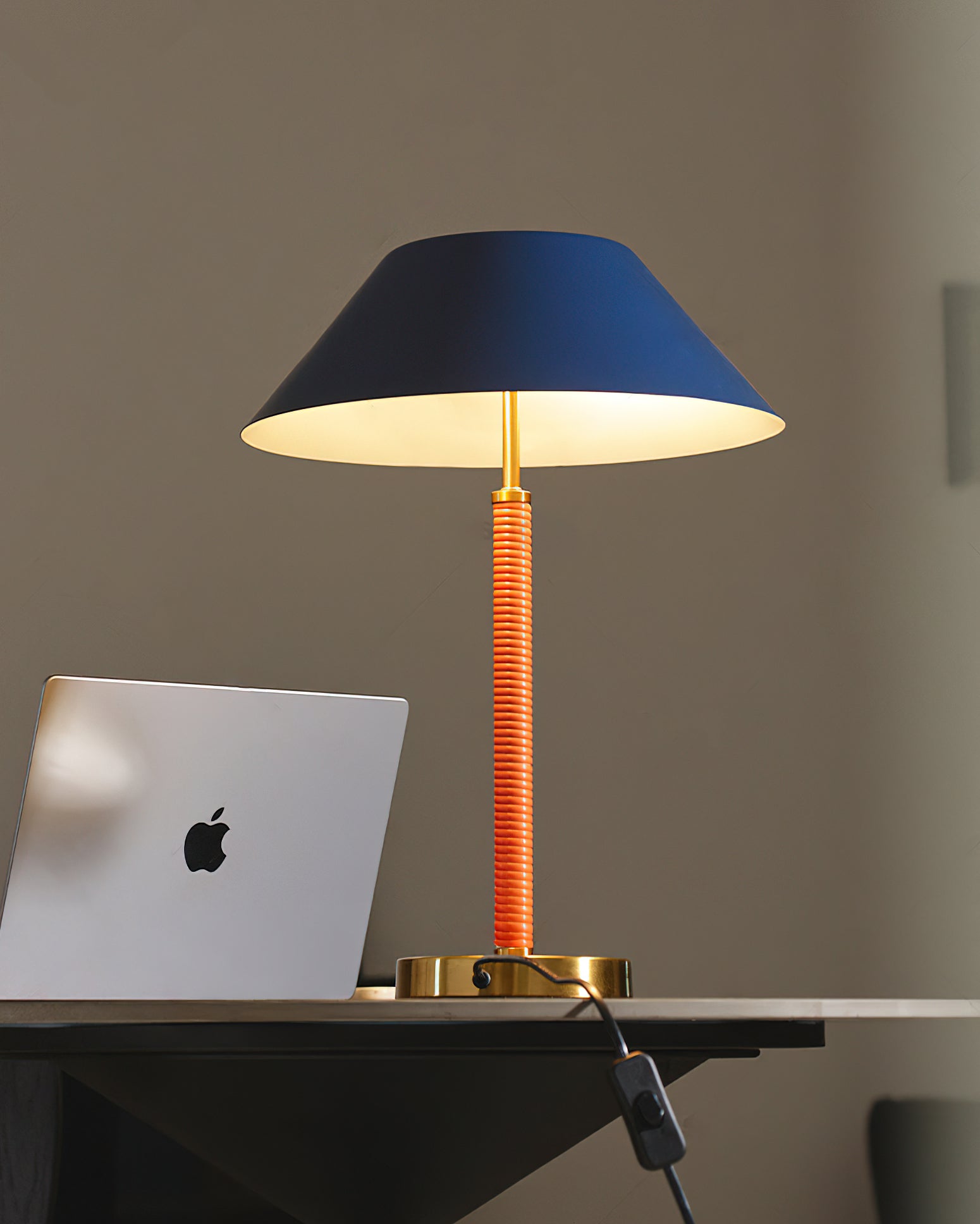 Detail shot of the lamp's golden base and blue shade.