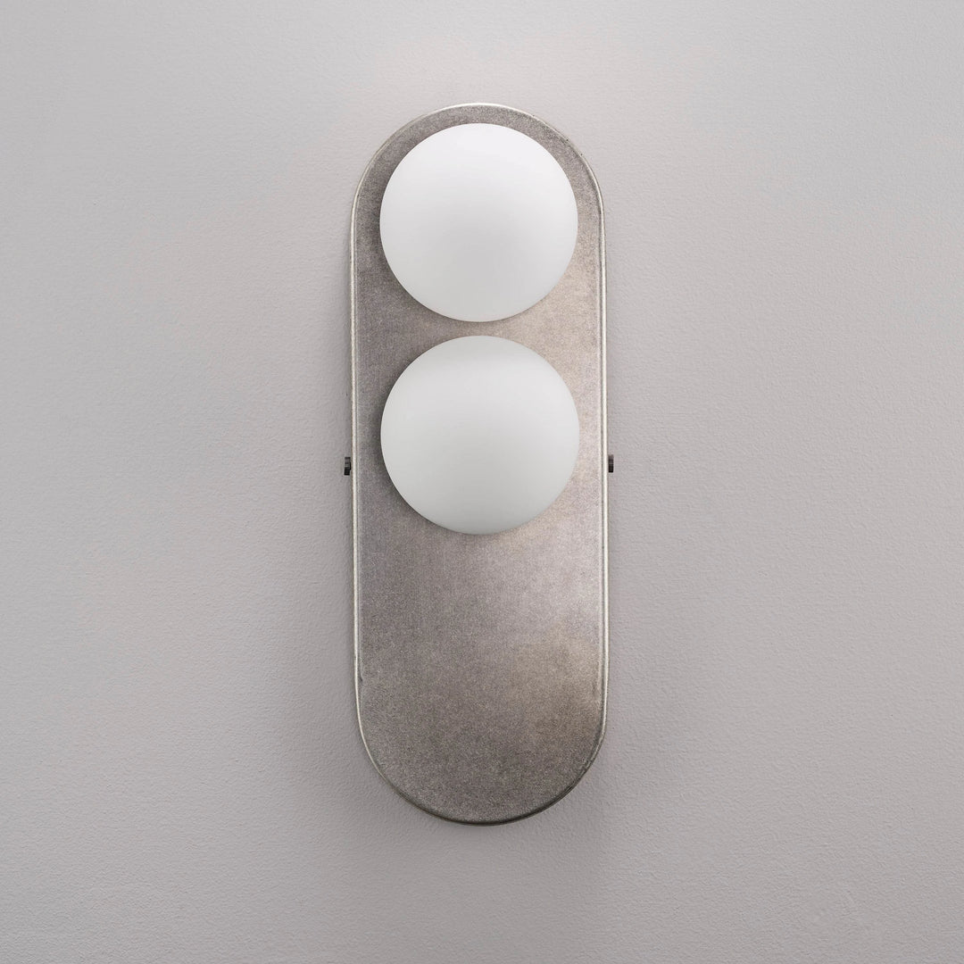 Side profile of the Eccolo Wall Lamp showing its curved backplate.