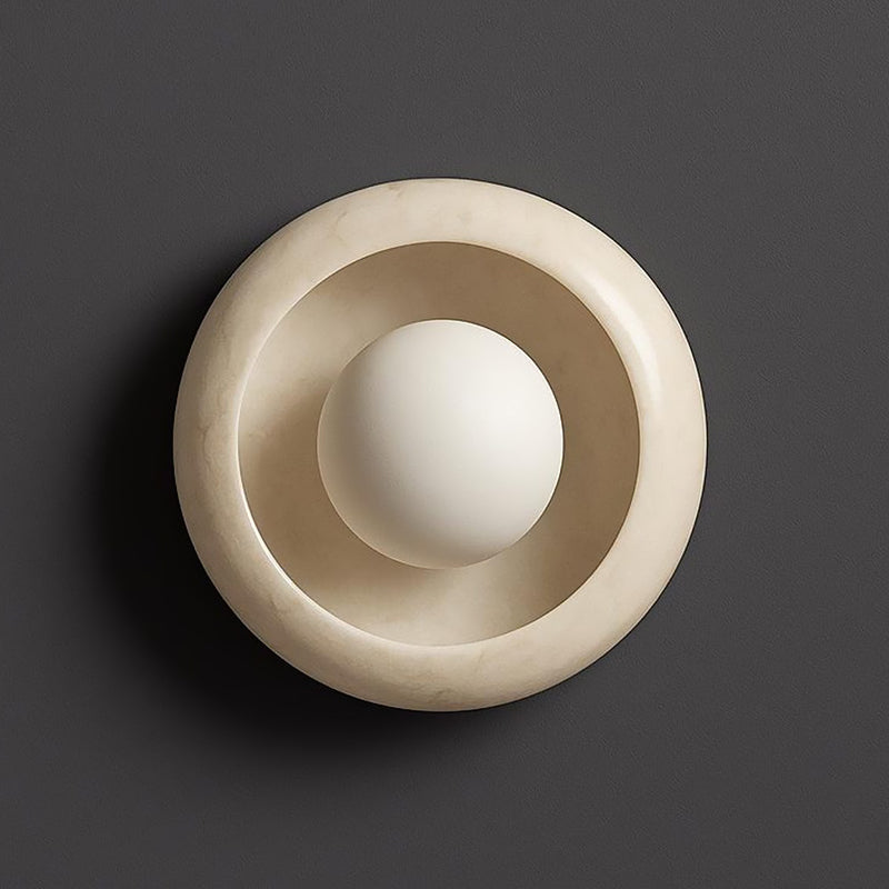 Lifestyle image showing the ambient light from the Eclipse Marble Wall Sconce.