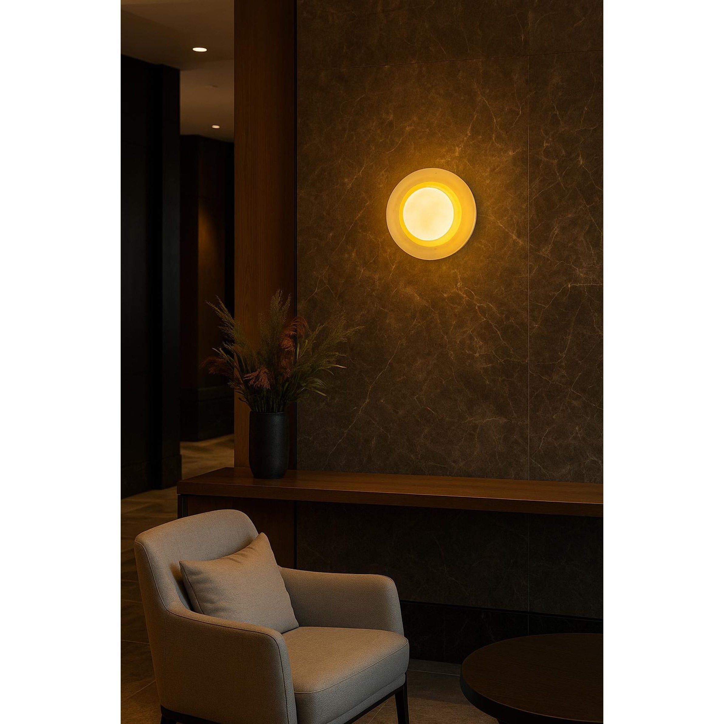 The Eclipse Marble Wall Sconce used as a bedside light in a contemporary bedroom.