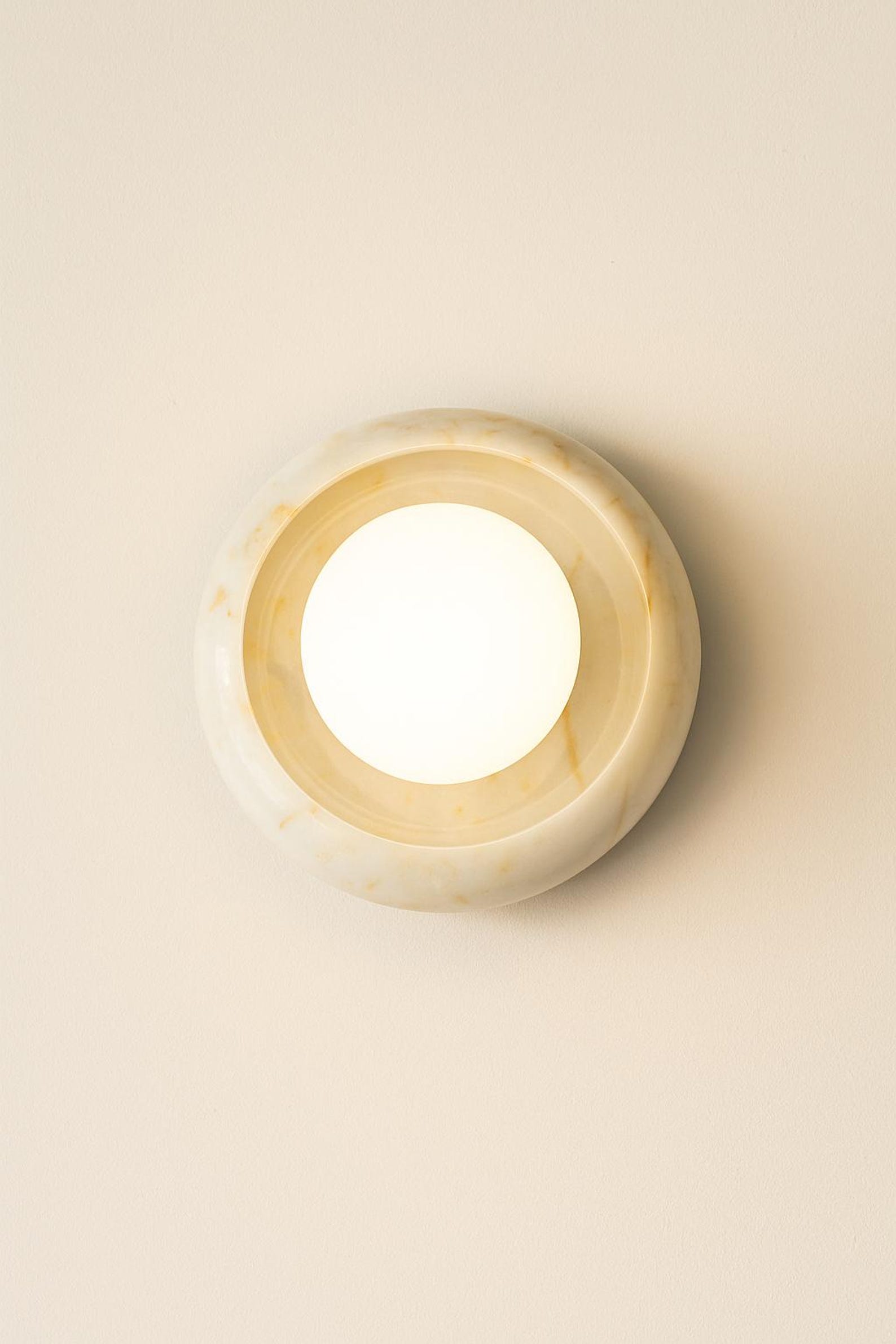 A pair of Eclipse Marble Wall Sconces installed in a living room setting.