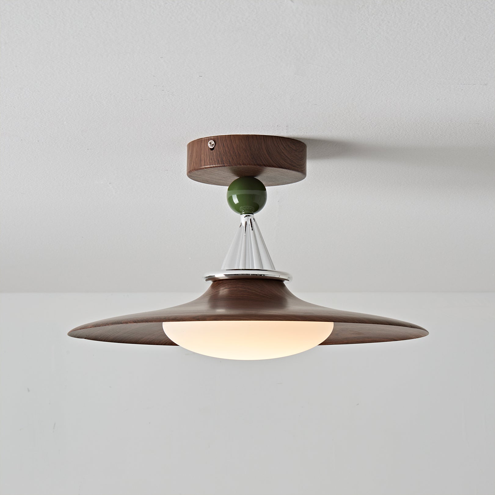 Eden Ceiling Light shown illuminated, casting a warm light.