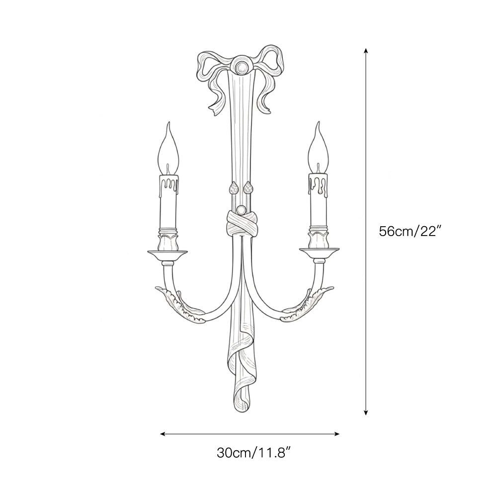 The Edith Brass Wall Lamp mounted on a dark wall.