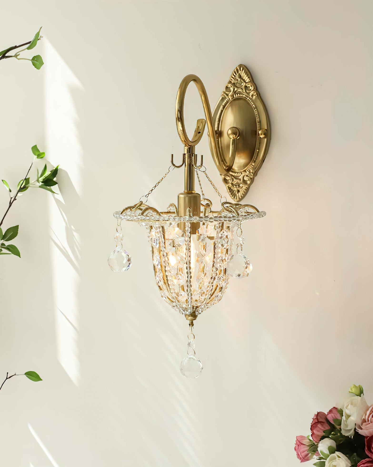 Close-up on the junction of the metal and crystal components of the wall light.