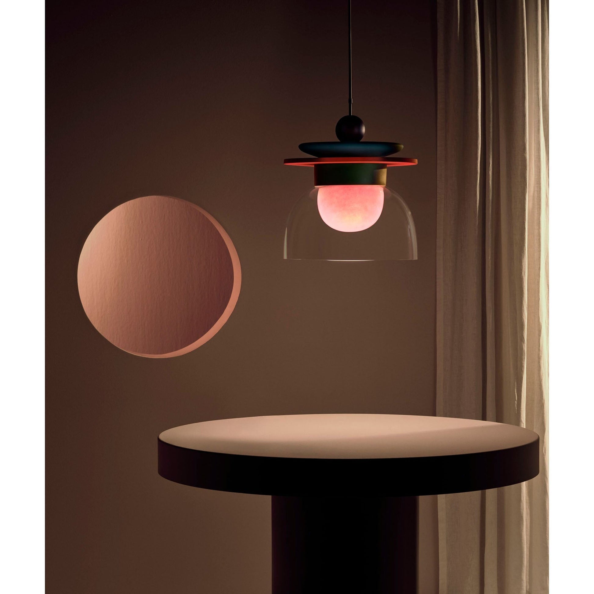 Lifestyle image of the Eirene Pendant Lamp in a minimalist bedroom.