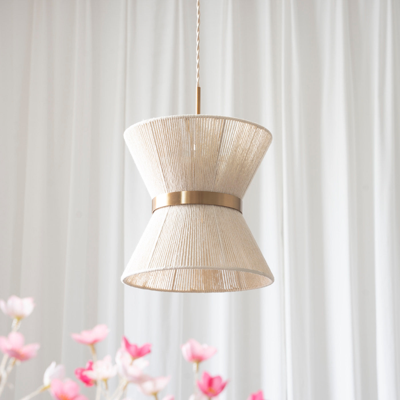 The intricate texture of the hand-woven cotton shade on the Elara pendant.
