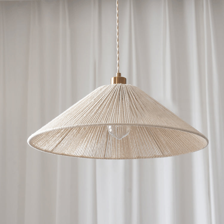 The wide drum-shaped Elara Woven Pendant Light shown in a bright, airy space.