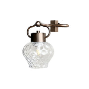 Eldorado Wall Lamp in bronze finish with a clear glass shade.