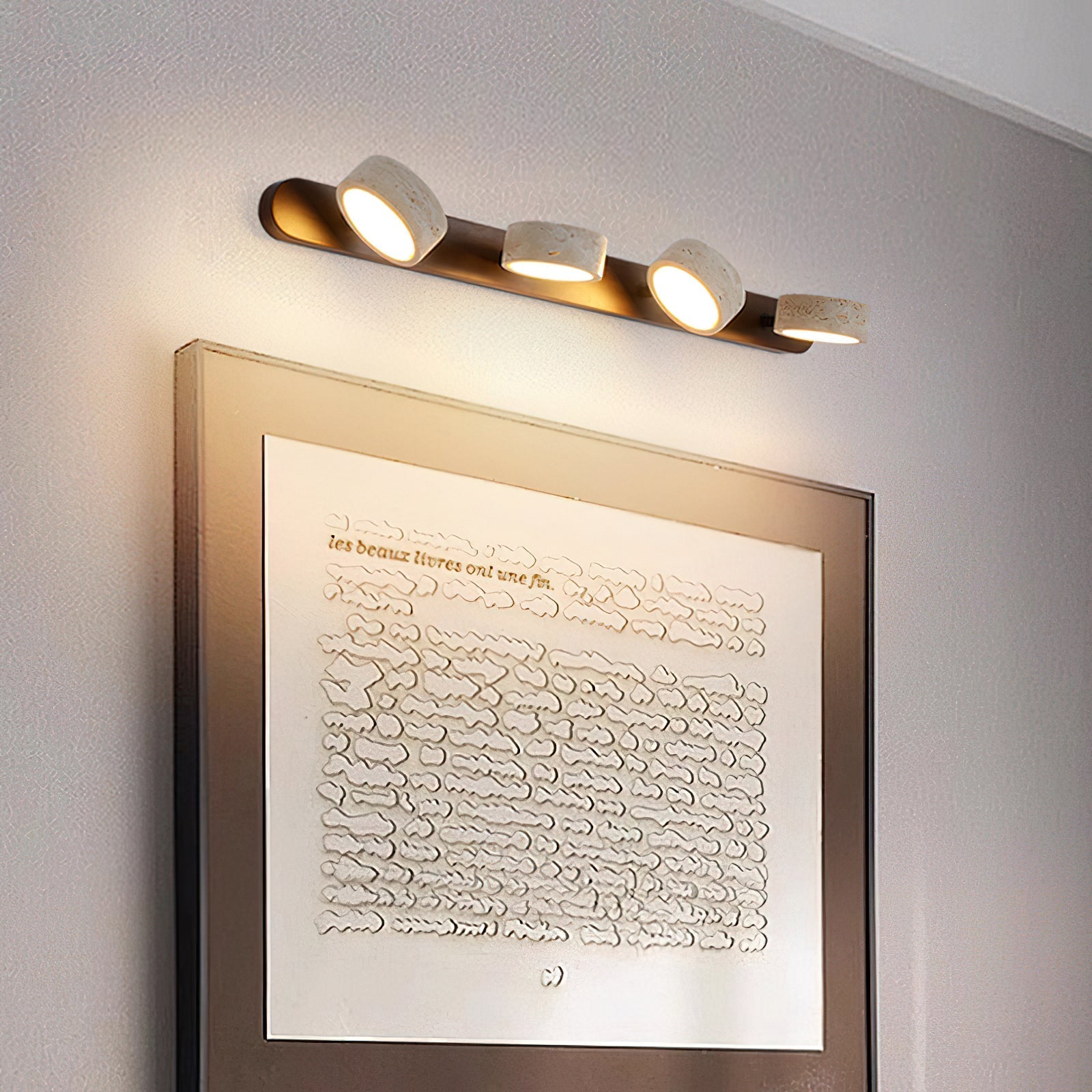 The 4-head Elias Travertine Wall Lamp, the largest size option.