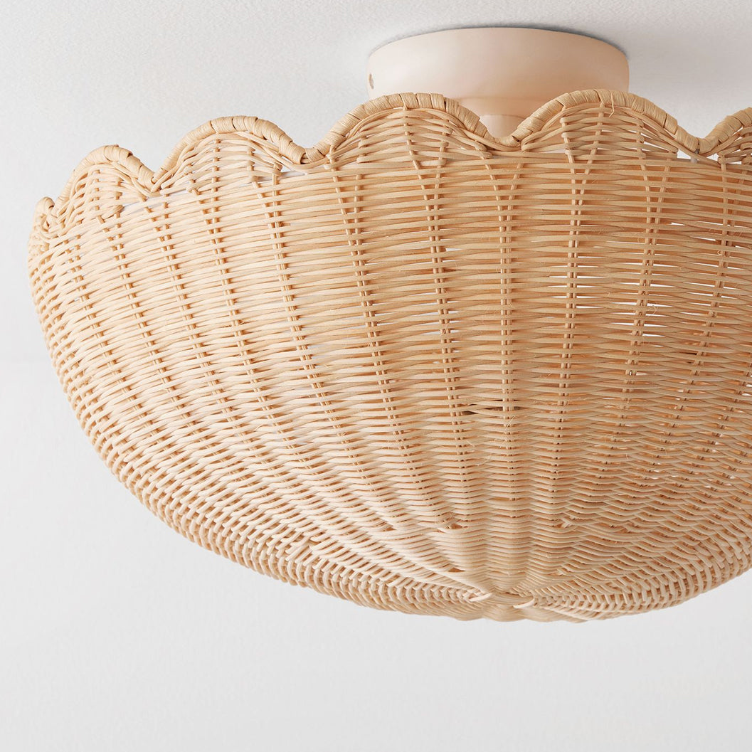 Detail shot showing the white metal frame and the texture of the raffia shade.