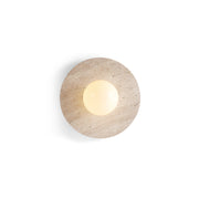 Elira Travertine Wall Lamp with circular stone base and glowing glass orb.