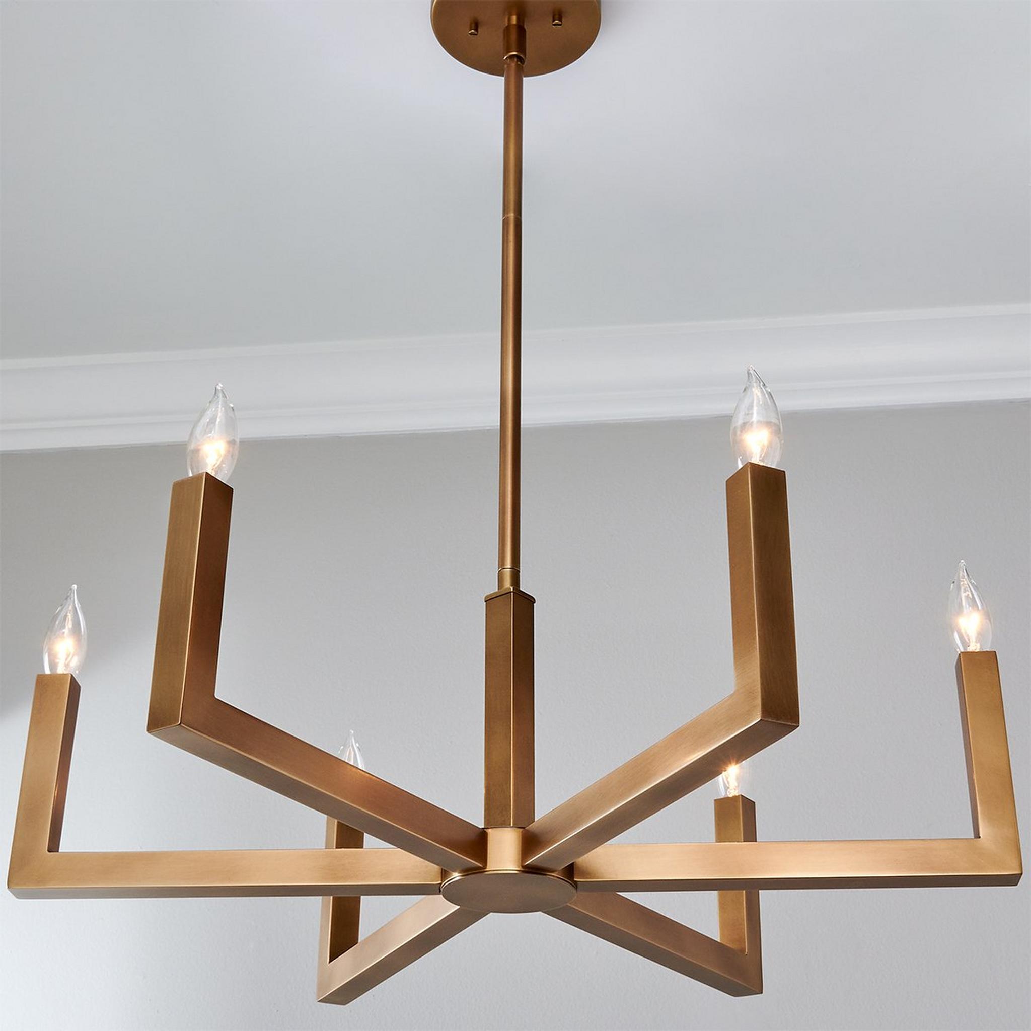 Close-up view of the Eliza Chandelier's brass arms and E12 sockets.