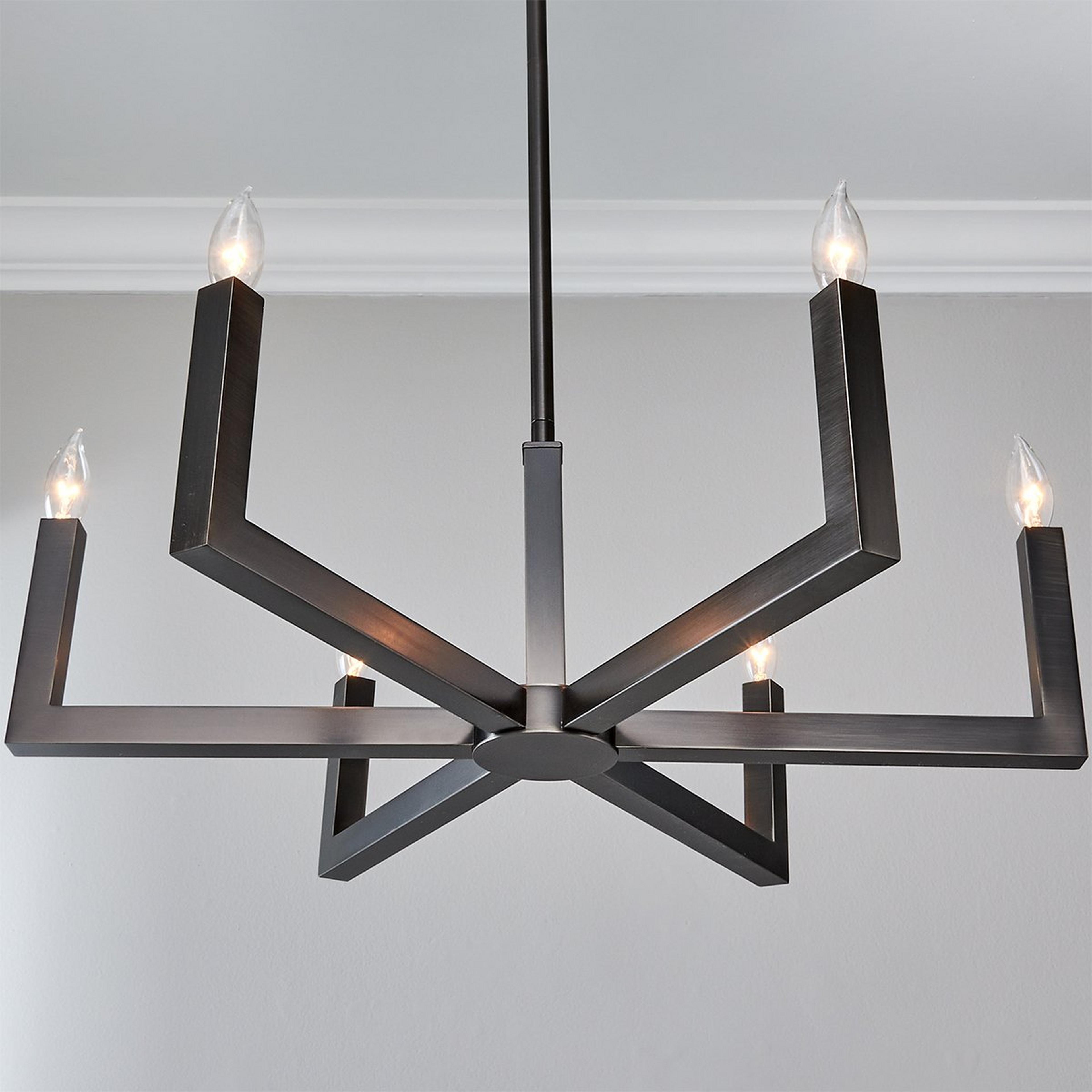 The black version of the Eliza Chandelier in a minimalist setting.
