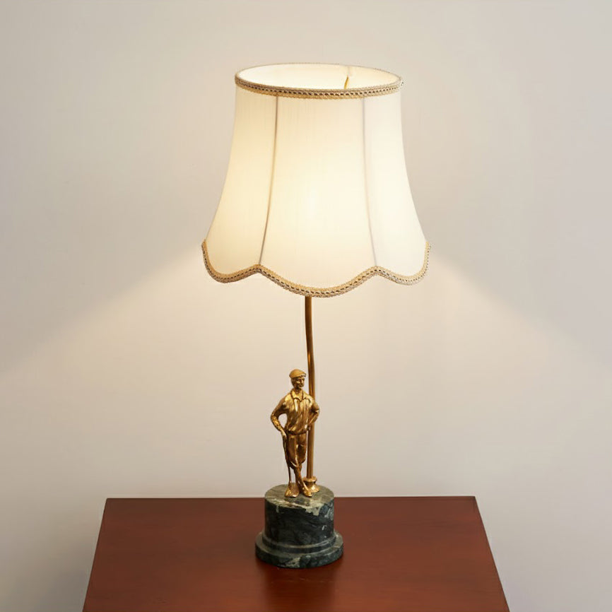 Close-up on the junction between the brass stem and marble base.