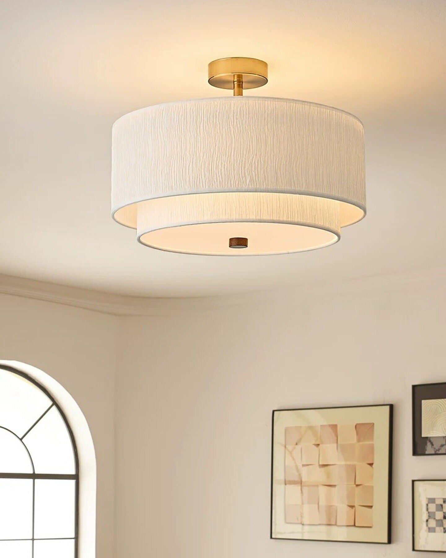 Lifestyle image of the Elodie light in a cozy reading nook.