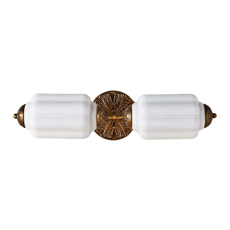 The Eloise Sconce in brass finish against a dark, dramatic wall.