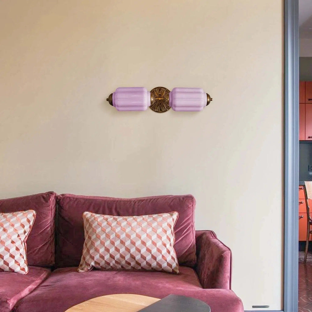 Angled view of the single-head brass sconce.