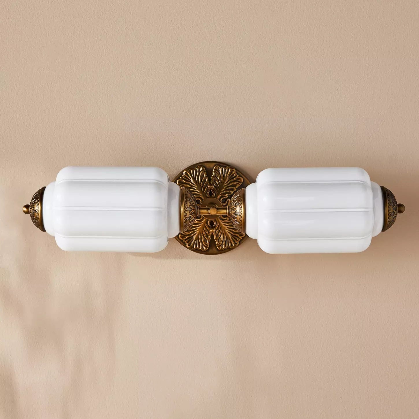 Lifestyle image showing the Eloise Sconce in a chic living room.