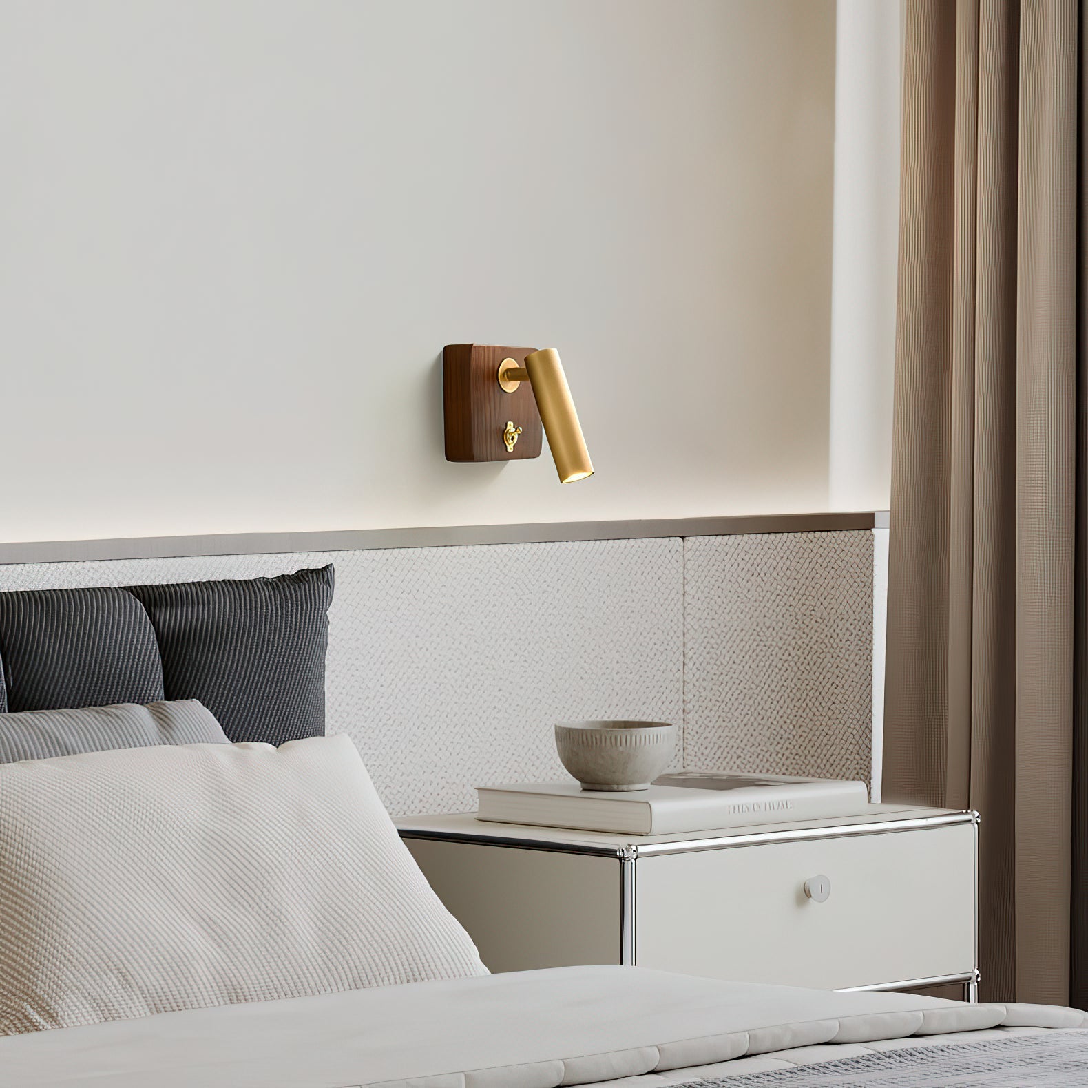 Enna Wall Lamp mounted vertically on a bedroom wall.