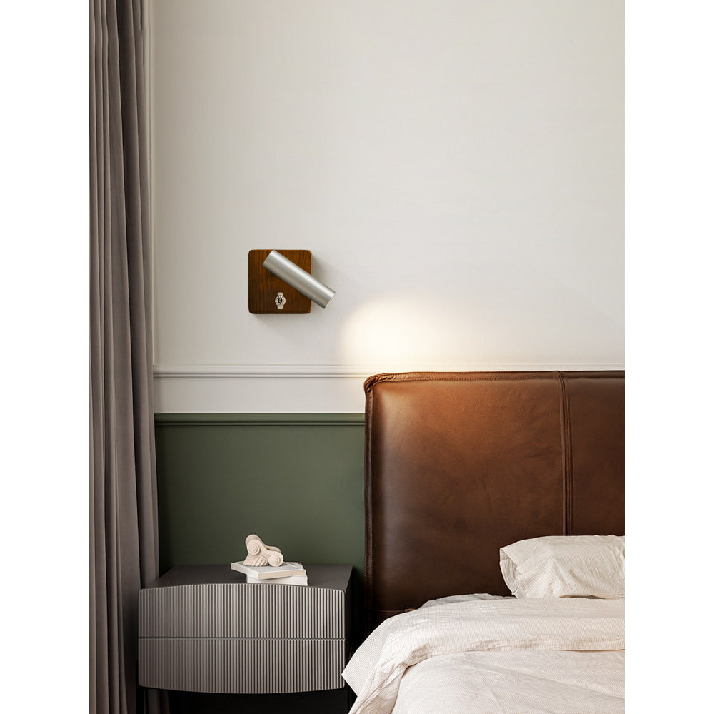 Enna Wall Lamp in a bedroom setting, used as a reading light.