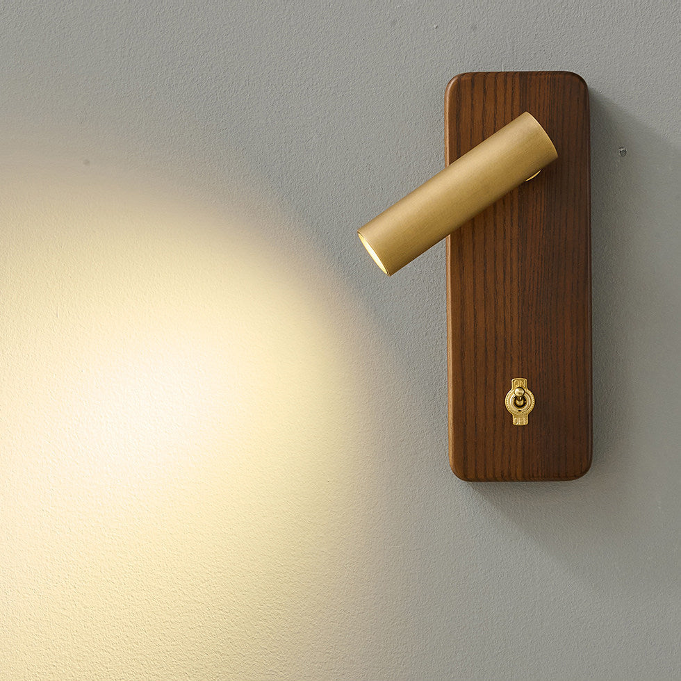 Enna Wall Lamp in walnut color finish, illuminated.