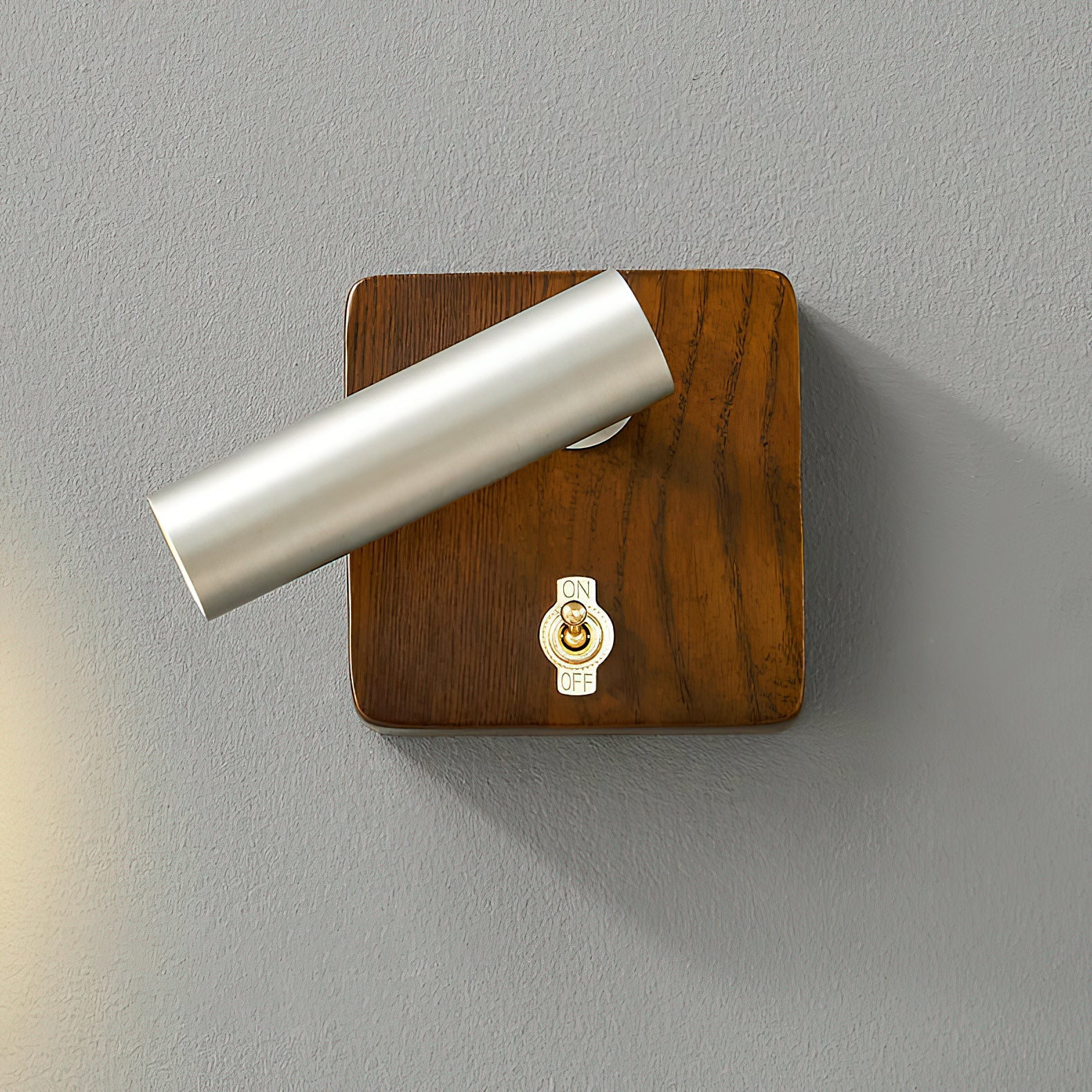 Enna Wall Lamp in brass finish, illuminated.