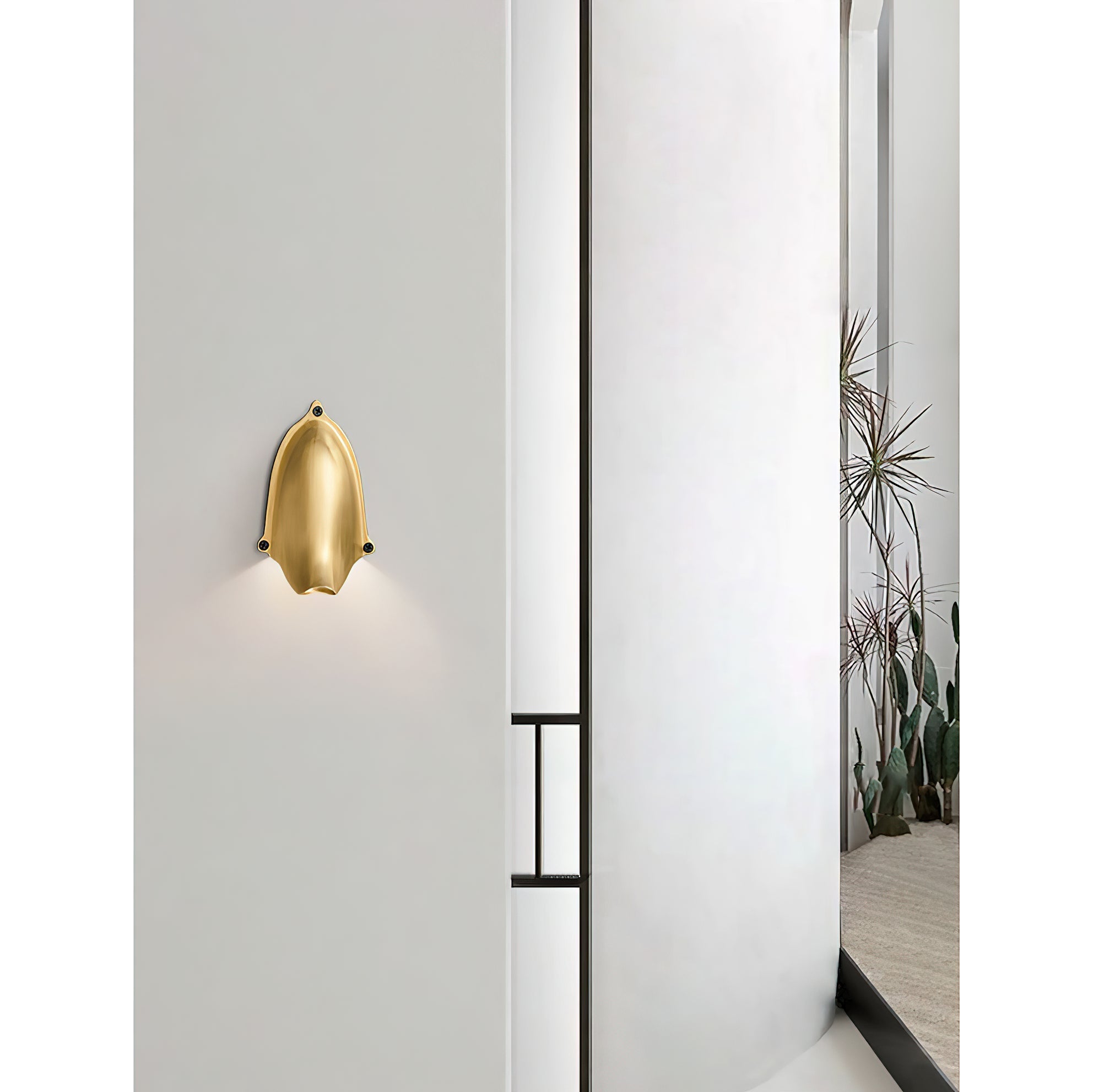 Detailed shot of the Enoki Wall Lamp's brass construction.