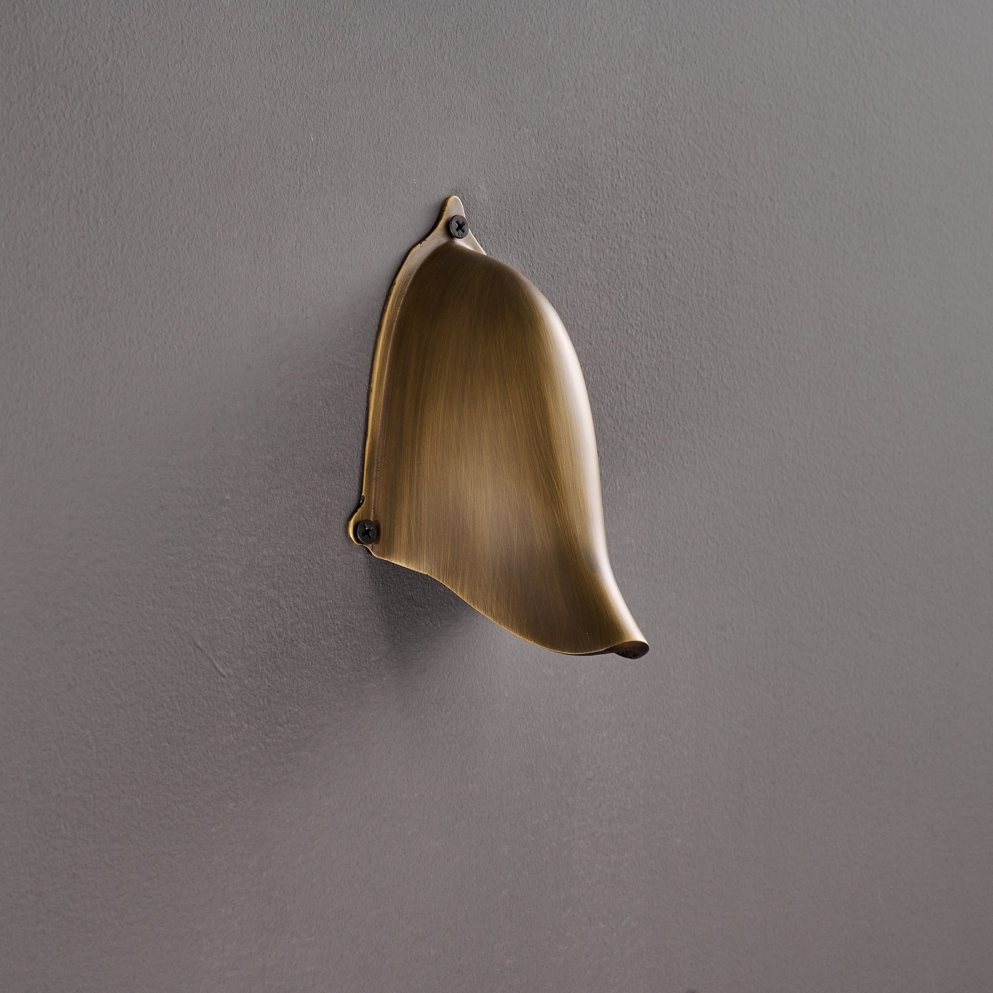 Enoki Wall Lamp in Antique Brass from a low angle.
