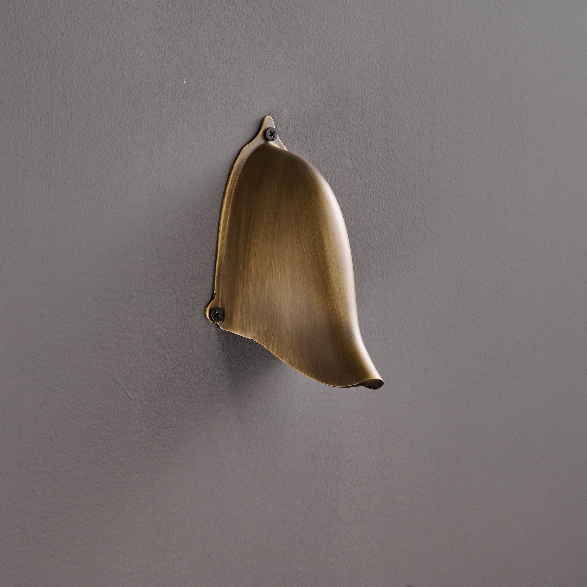 Enoki Wall Lamp in Antique Brass from a low angle.