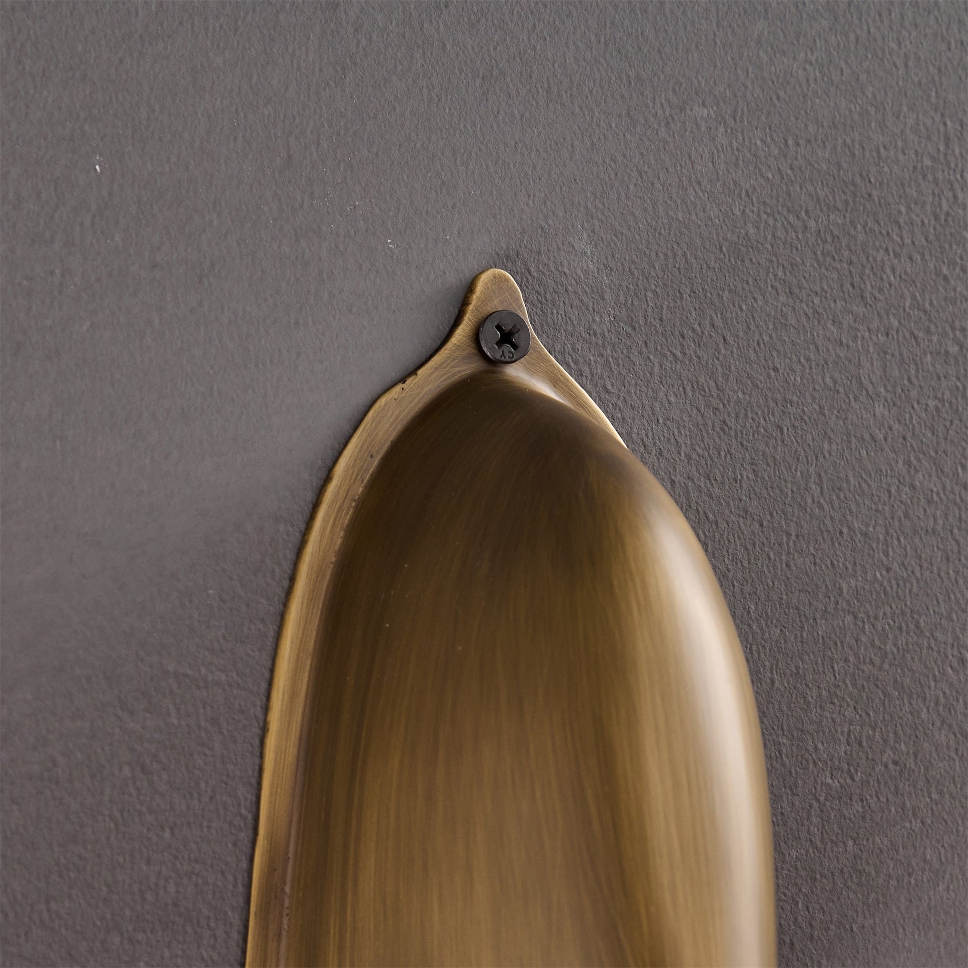 Enoki Wall Lamp in Silver, shown in a living room context.
