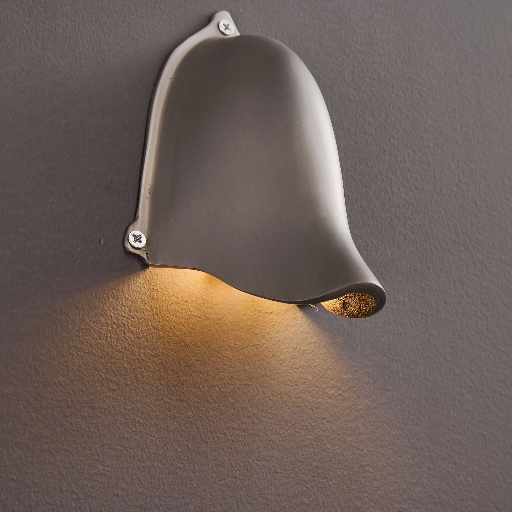 The sleek lines of the Enoki Wall Lamp in Silver.