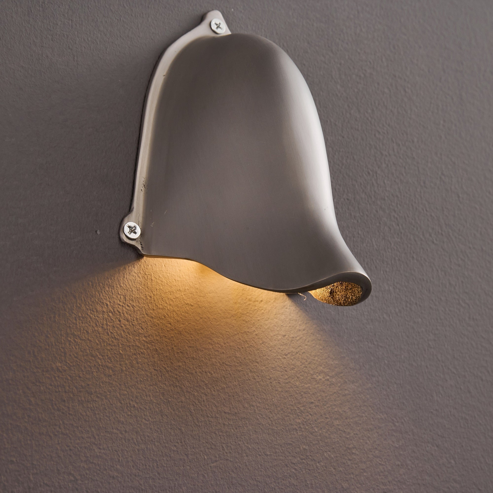 The sleek lines of the Enoki Wall Lamp in Silver.