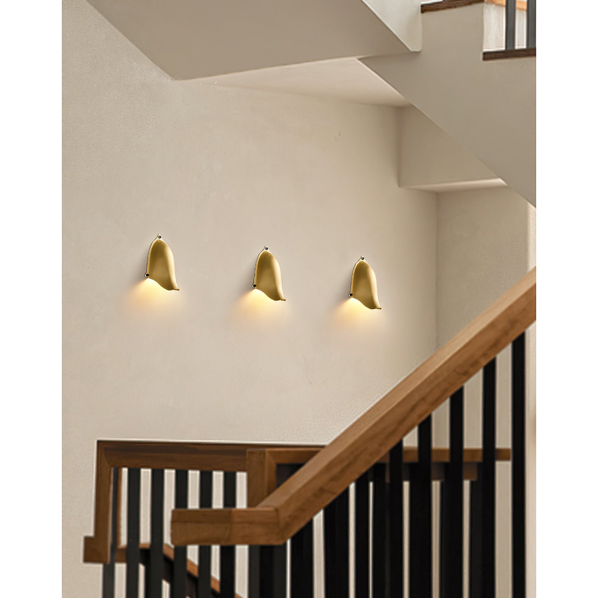 Enoki Wall Lamp in Silver finish against a dark wall.