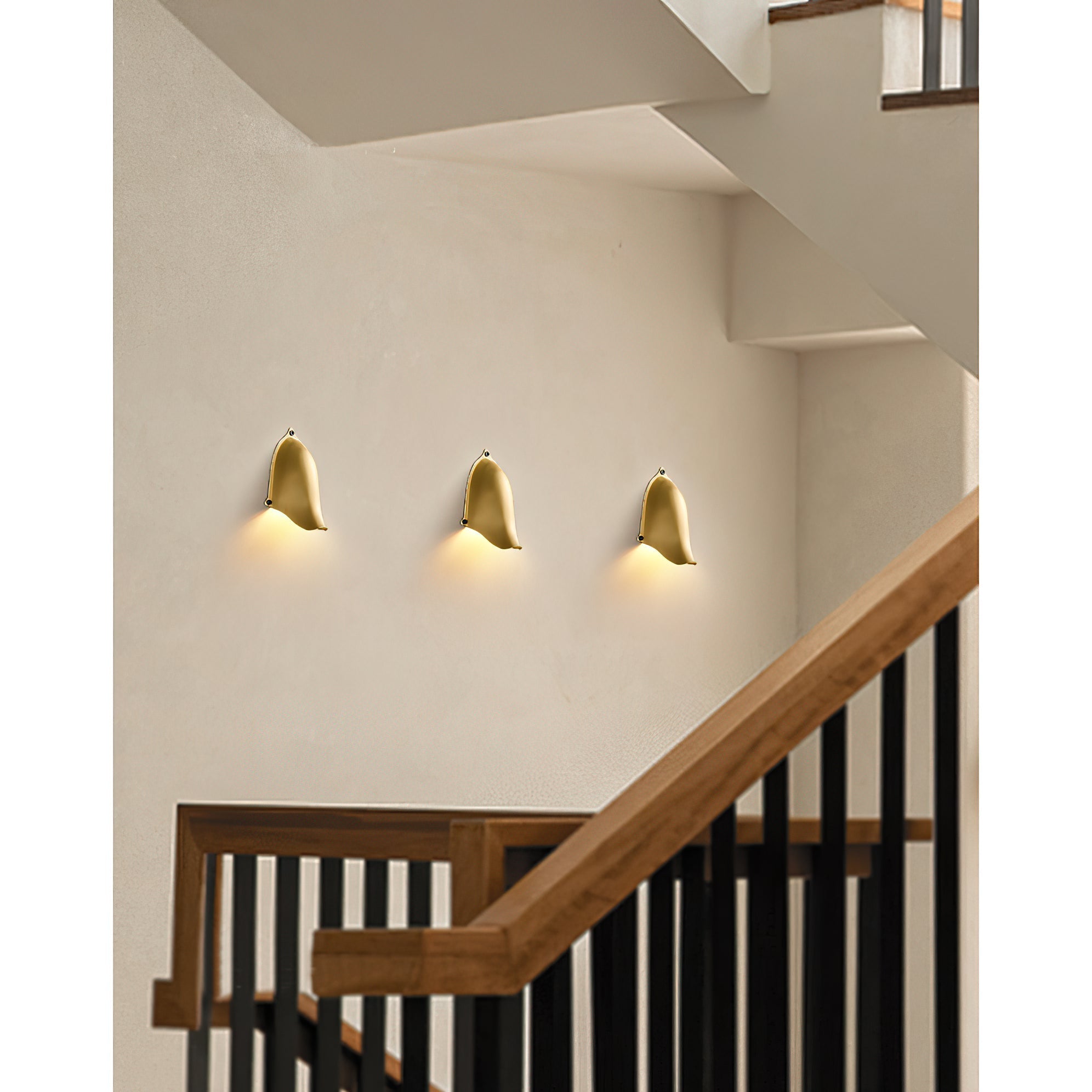 Enoki Wall Lamp in Silver finish against a dark wall.