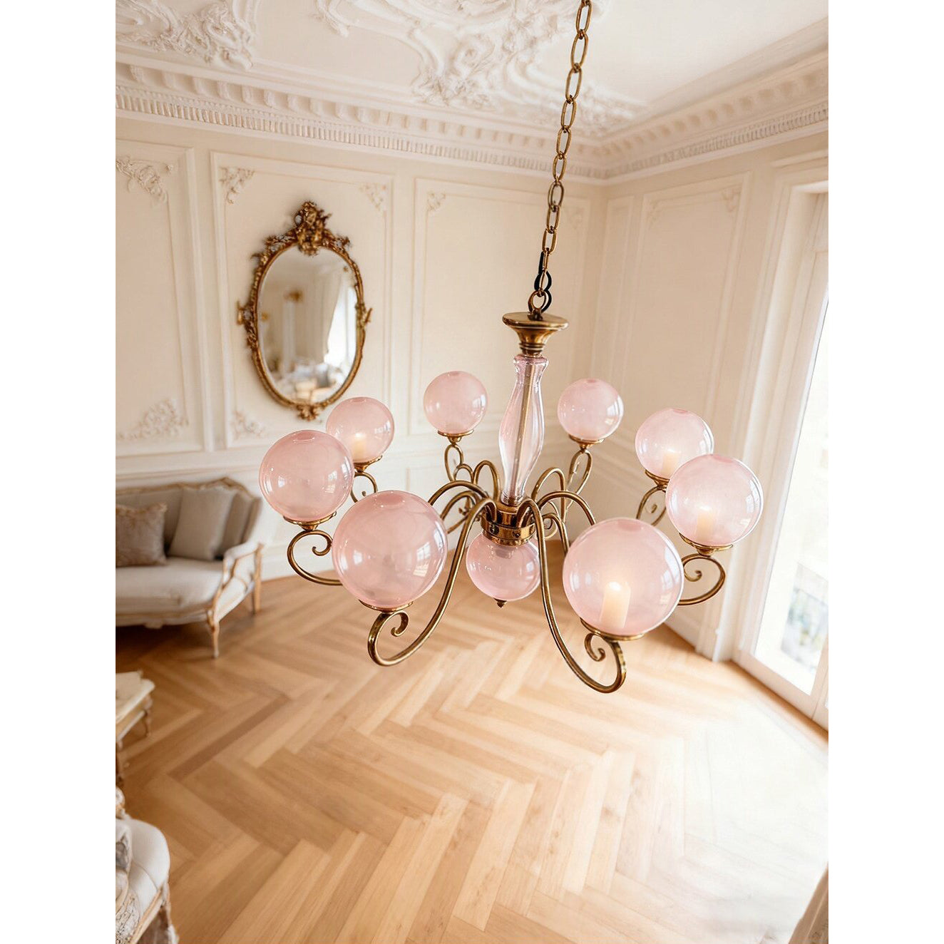 The small decorative finial at the base of the chandelier.