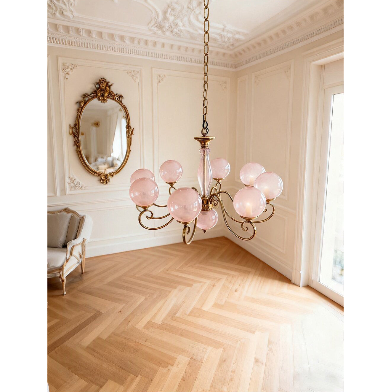 A lifestyle image of the Evelyn Chandelier in a bedroom with blush pink globes.