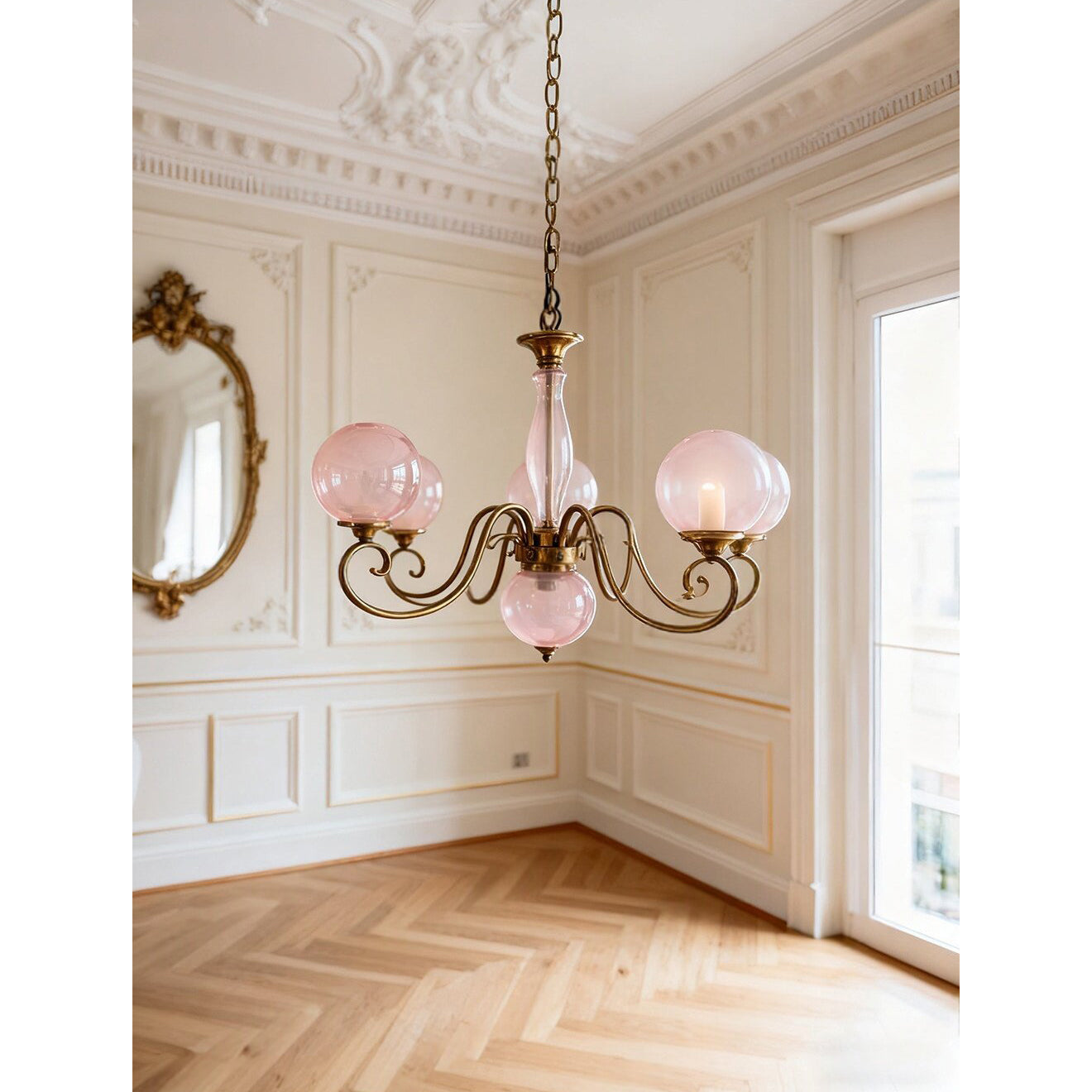 A lifestyle image of the Evelyn Chandelier in a bay-window reading nook.