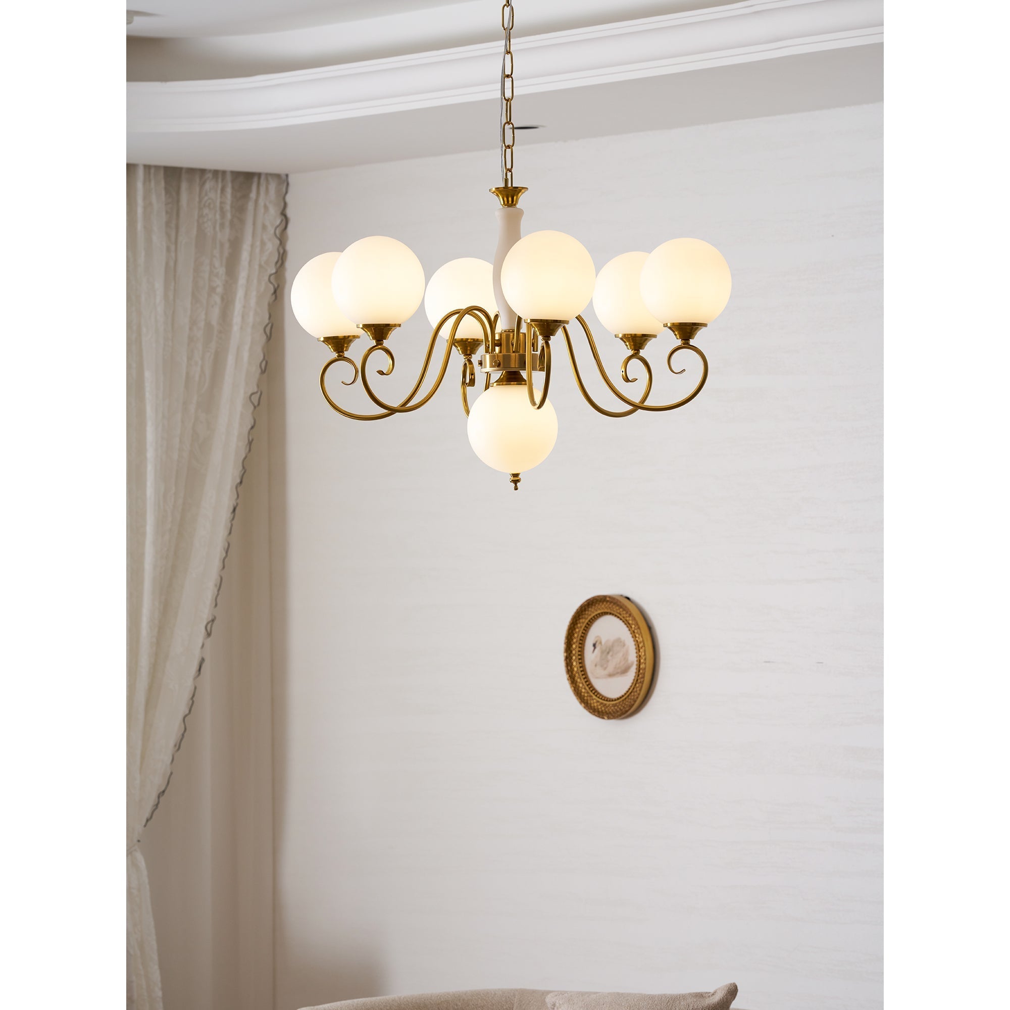 Evelyn Glass Chandelier with pale blue globes, illuminated.
