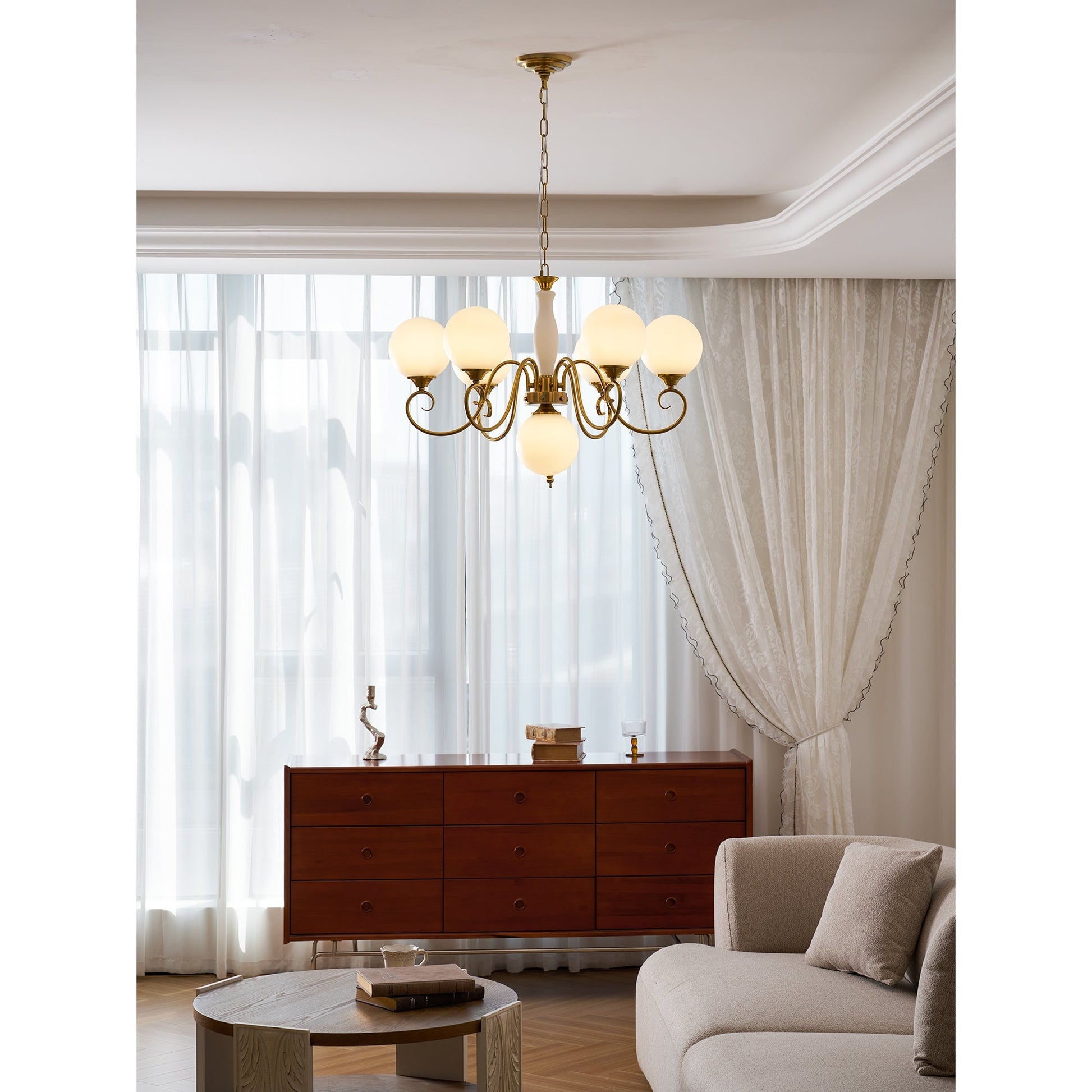 Evelyn Glass Chandelier with clear globes, illuminated.
