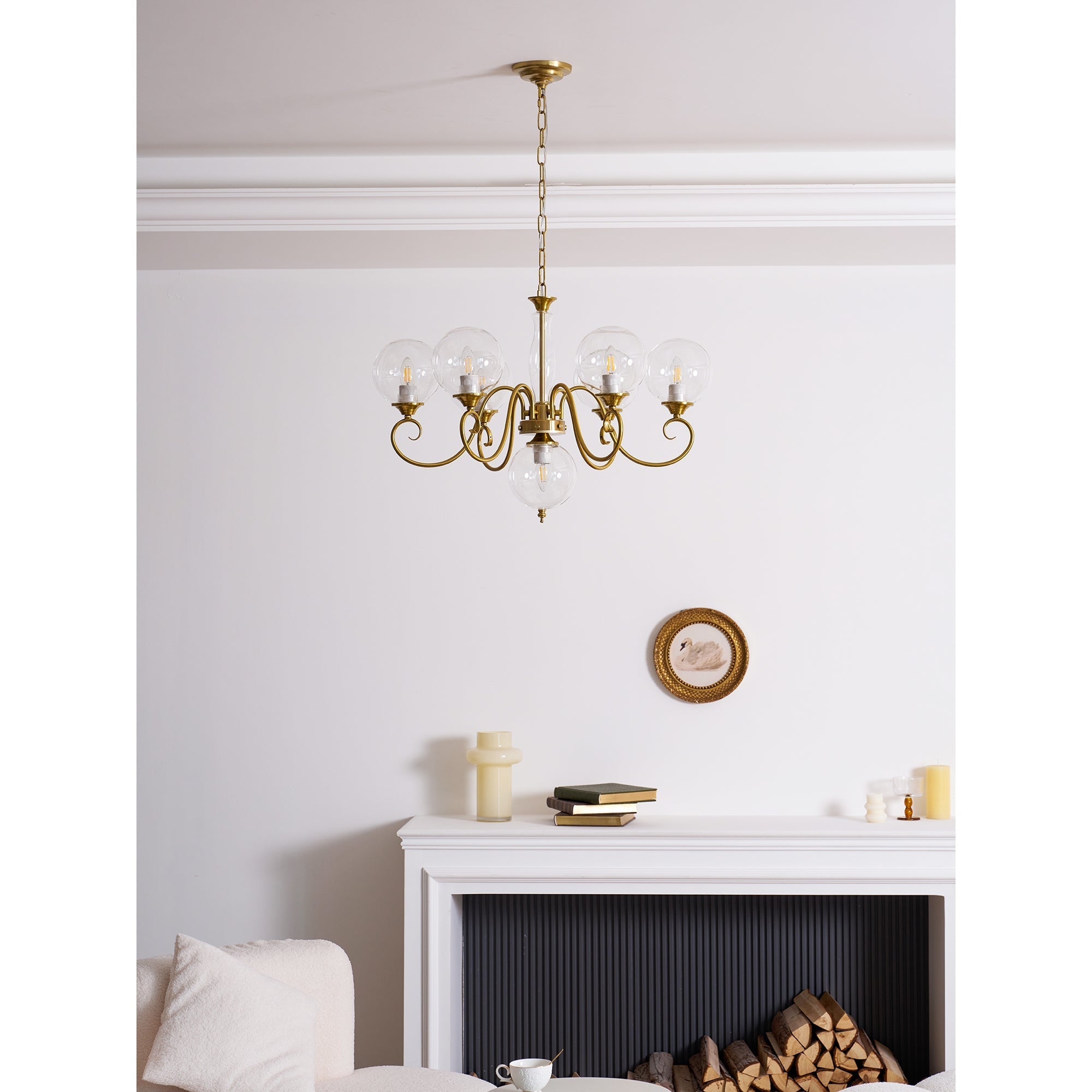 Evelyn Glass Chandelier with white globes, illuminated.