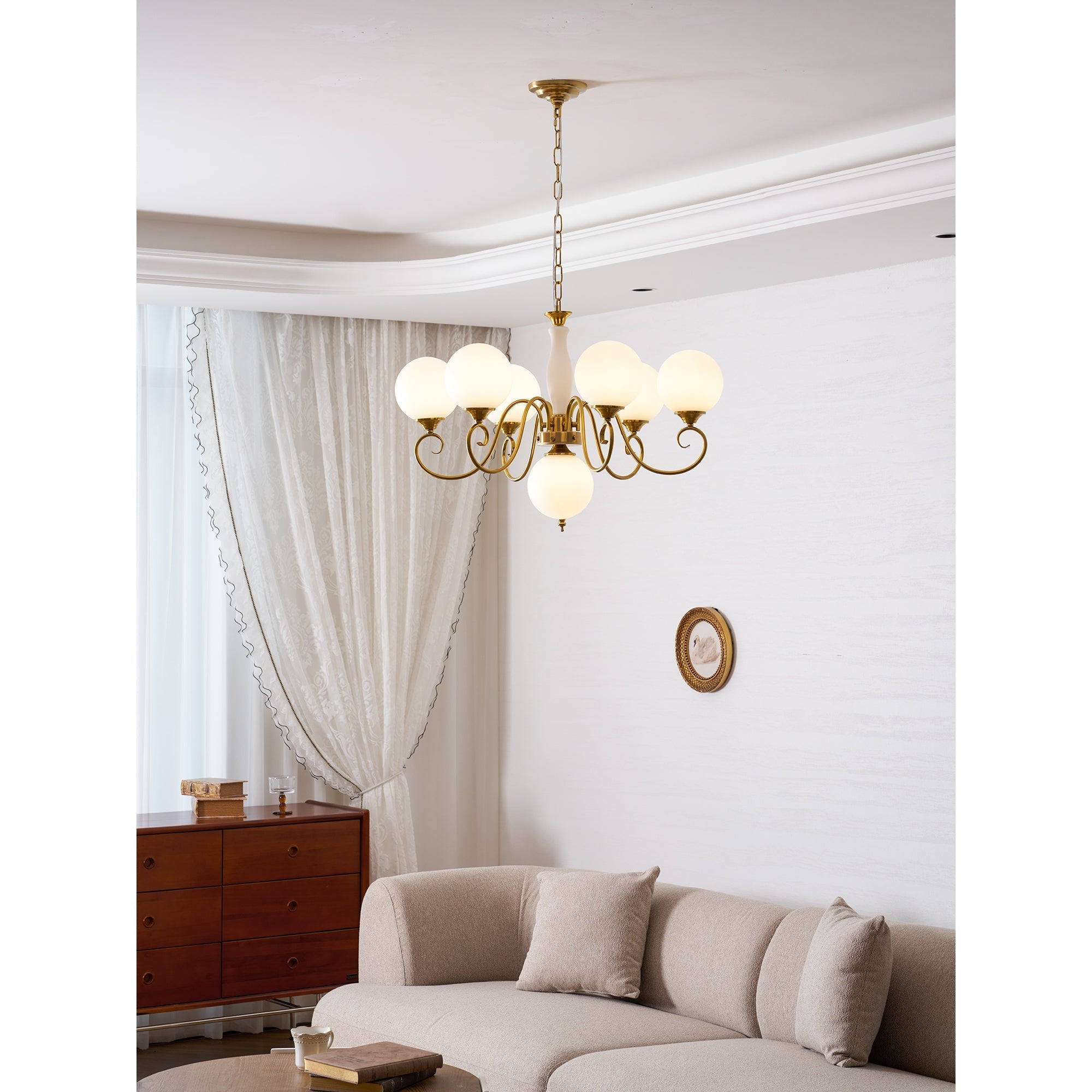 Full view of the 3+1 head chandelier against a light wall.