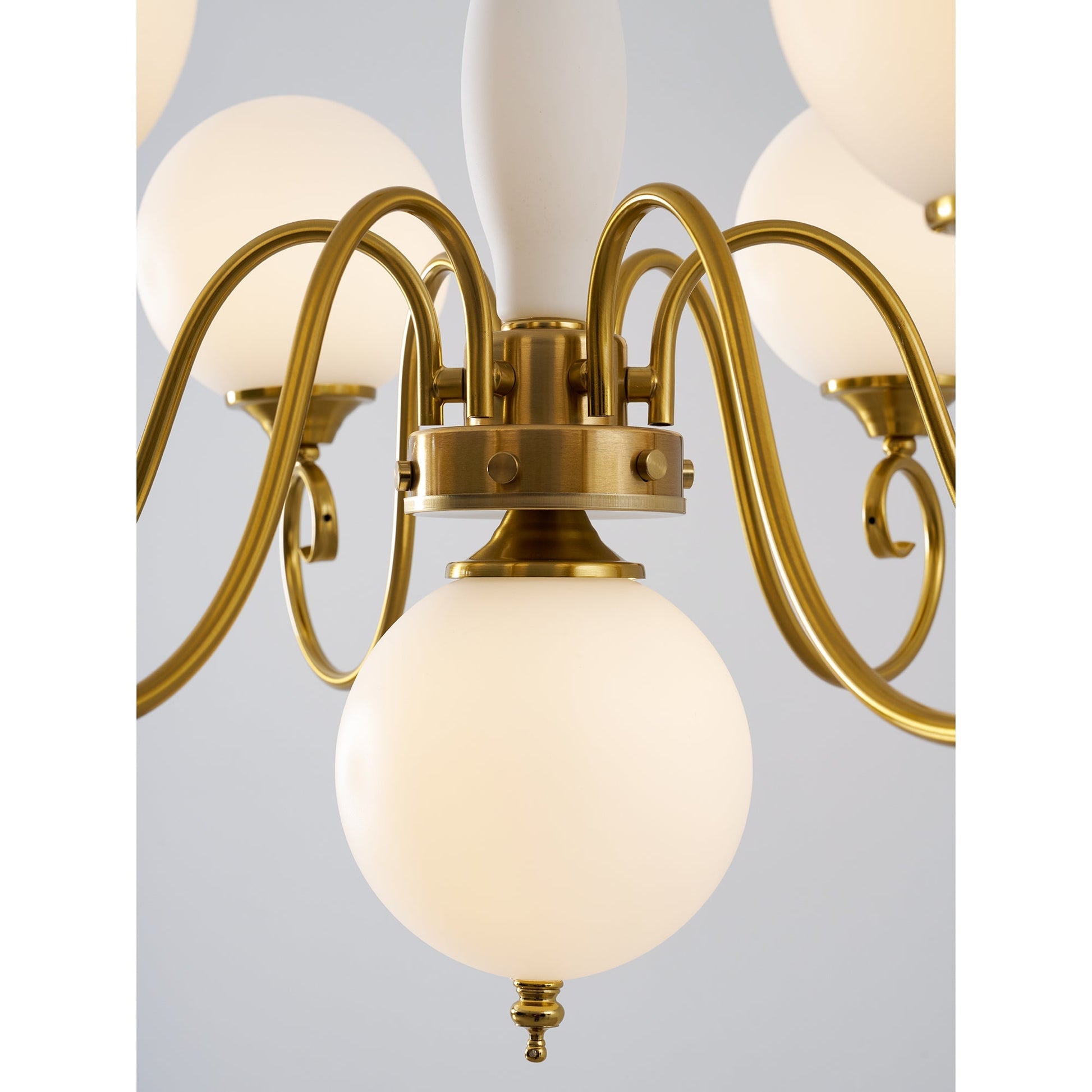 The chandelier as a centerpiece in a room with classic decor.