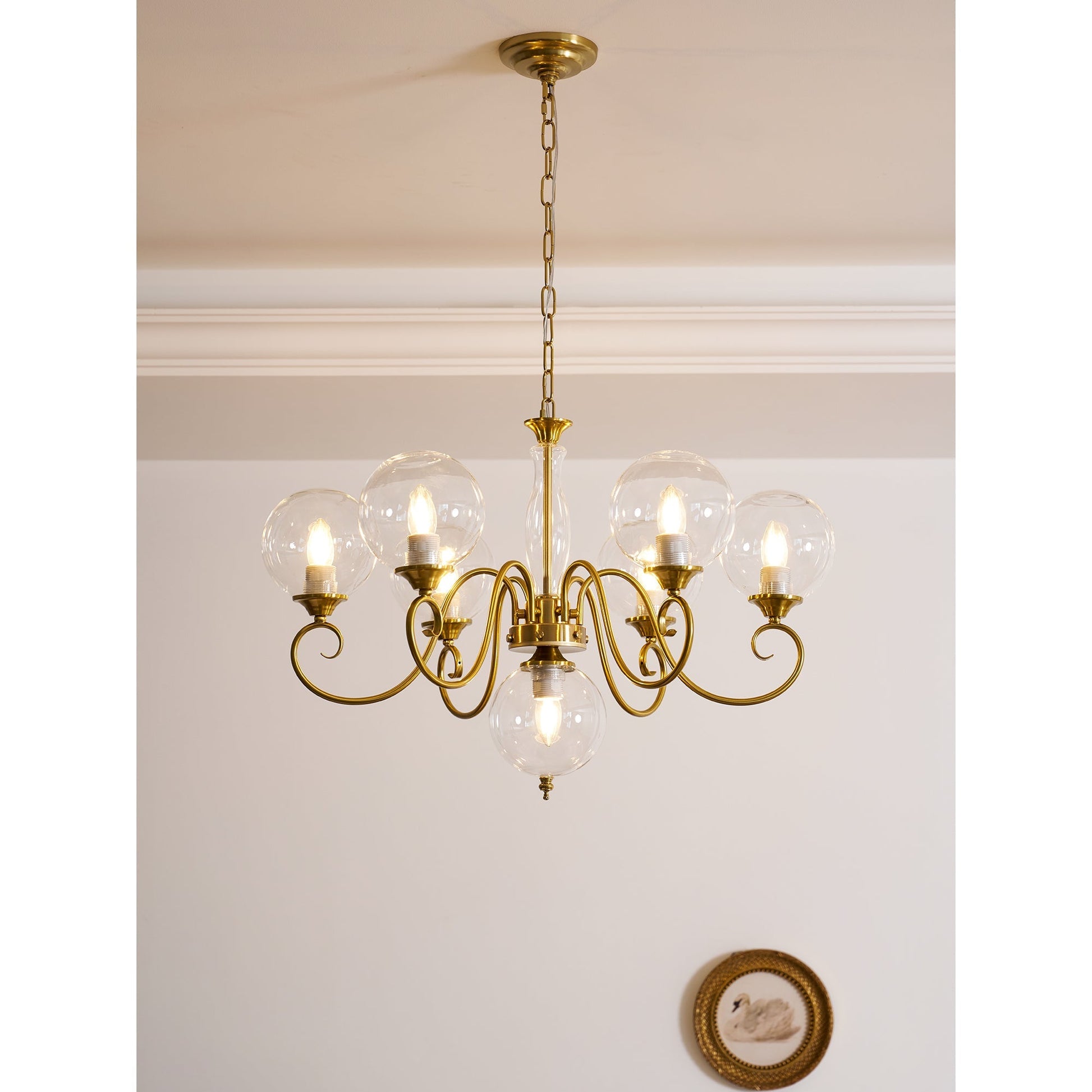 Evelyn Glass Chandelier with white globes, unlit.