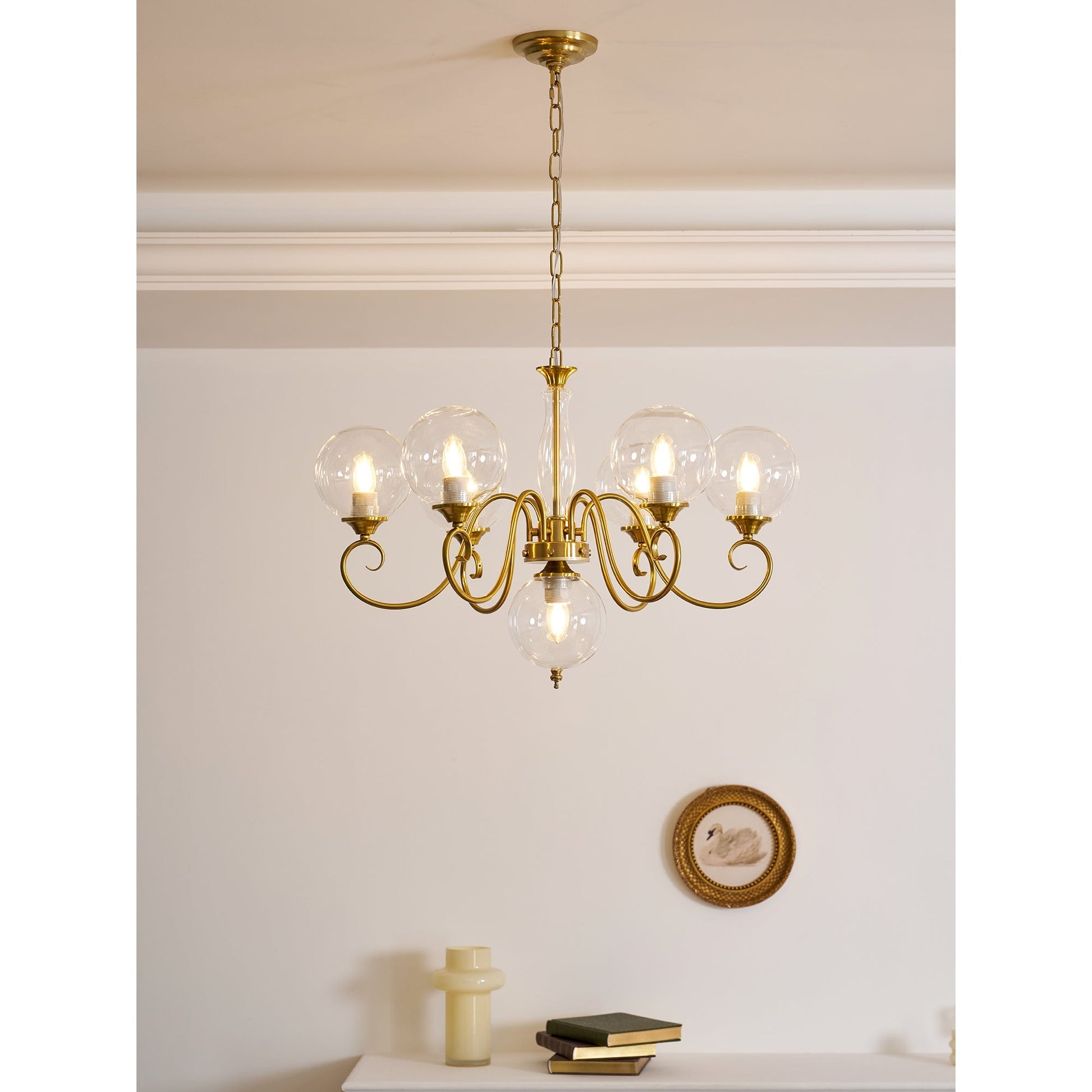 Full view of the 8+1 head chandelier against a dark wall.