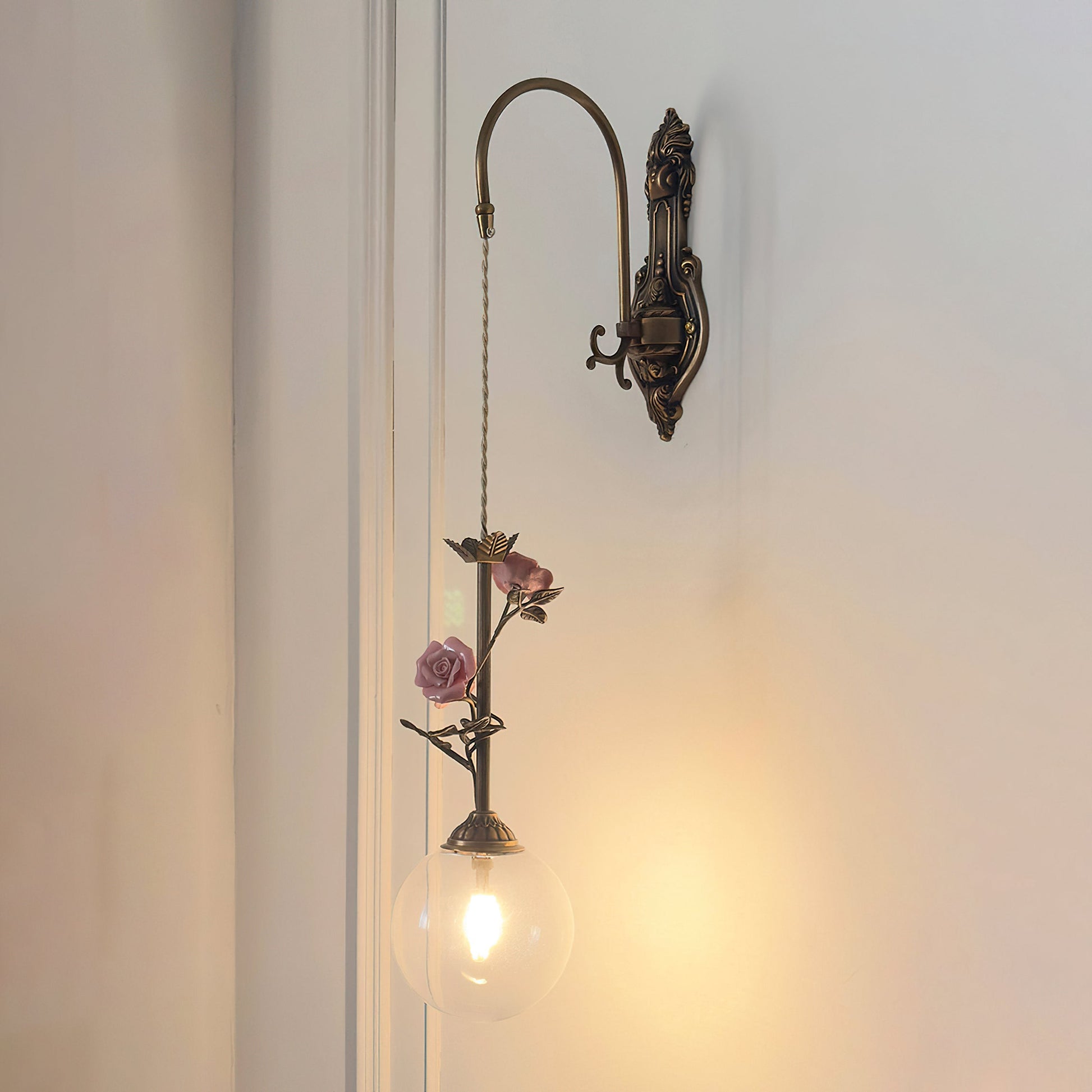 The pink glass rose sconce, unlit, showing its daytime appearance.